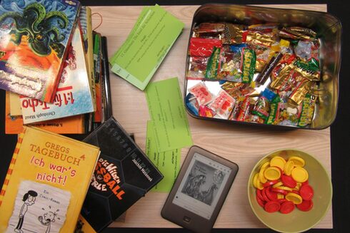 BÜcher, Tablet, Chip und Süßigkeiten für das Bücherbingo