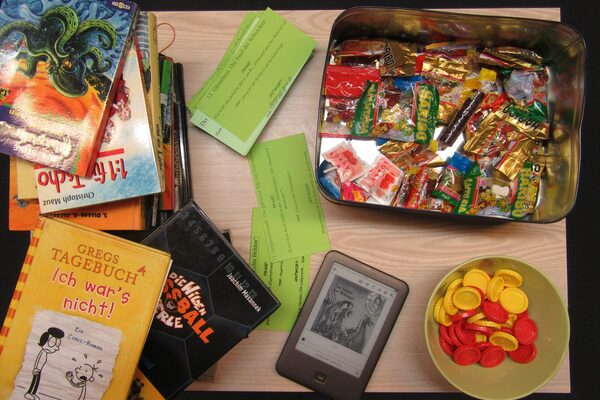 BÜcher, Tablet, Chip und Süßigkeiten für das Bücherbingo